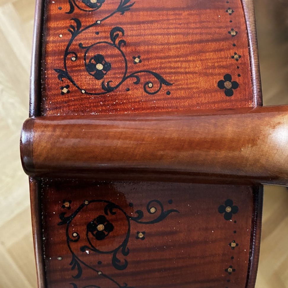 Decorative floral scrollwork on the body of the Wordsworth Quartet instrument
