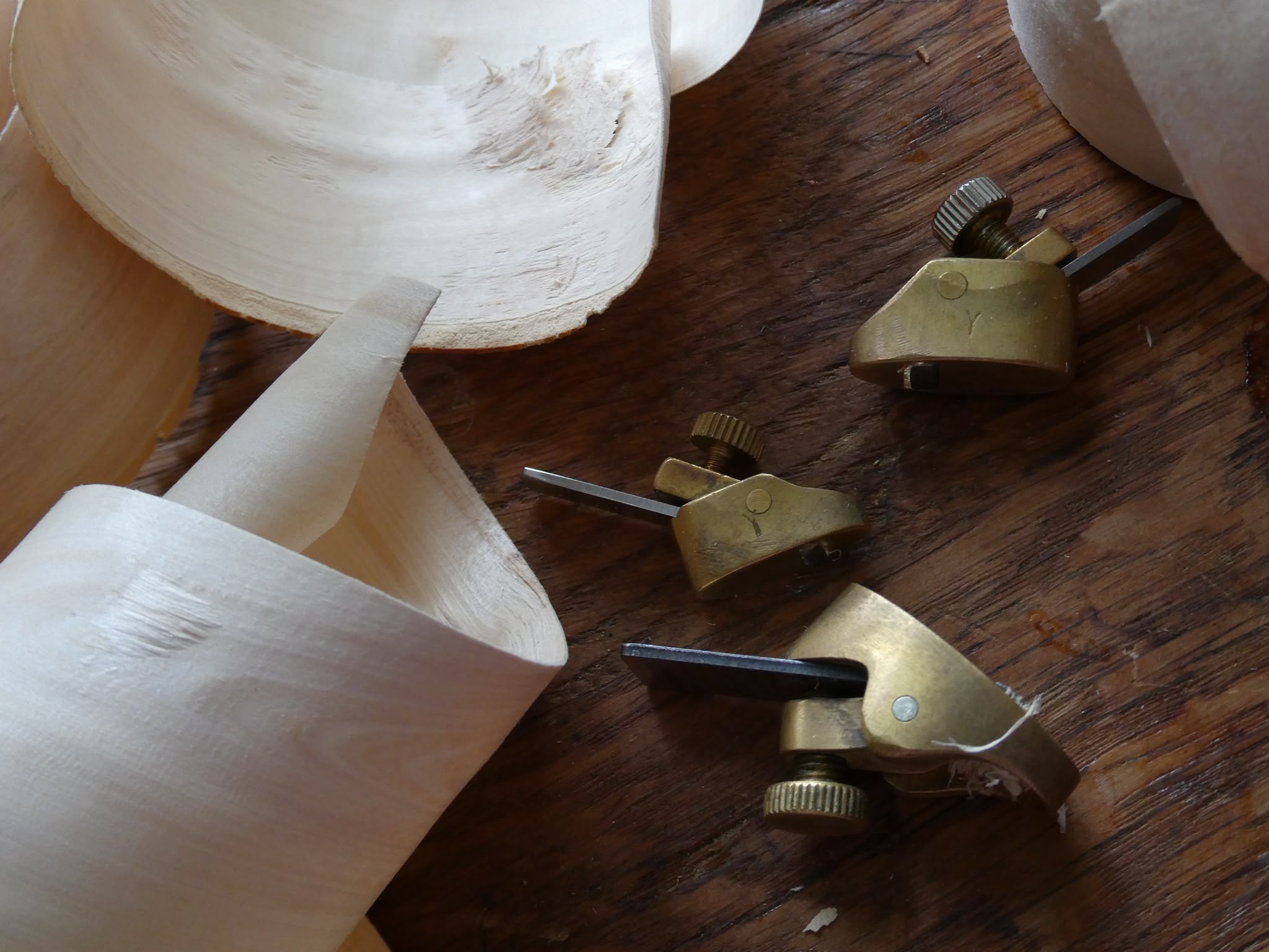Violin scroll and luthier tools on the workbench